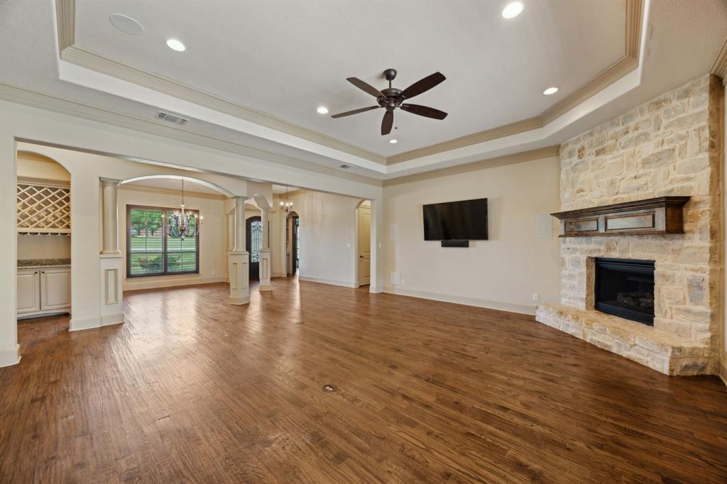 301 Harrison Circle Van Alstyne, TX 75495 - Photo 9 of 38 a view of a livingroom with wooden floor and a fireplace