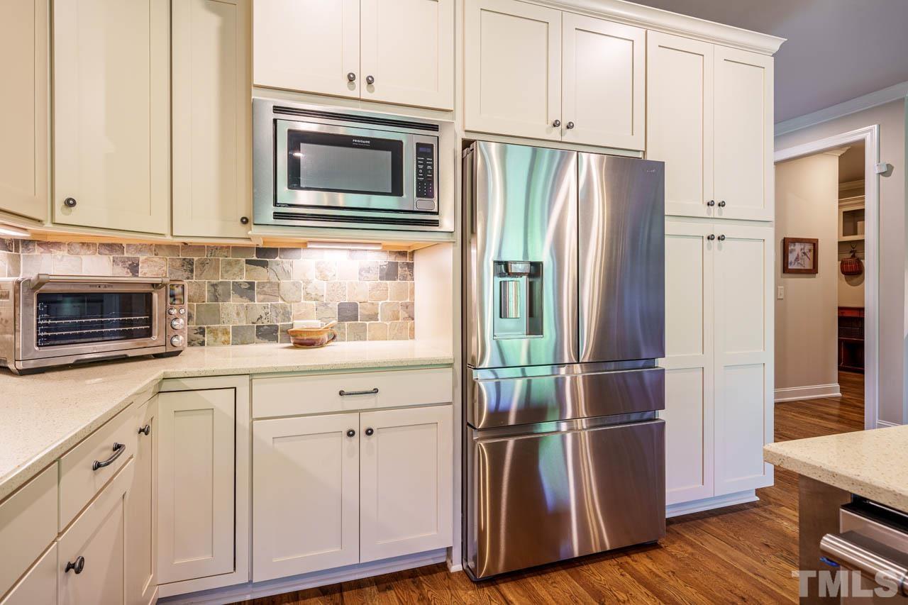 394 Cliffdale Road Chapel Hill, NC 27516 - Photo 16 of 66 a kitchen with cabinets stainless steel appliances and wooden floor