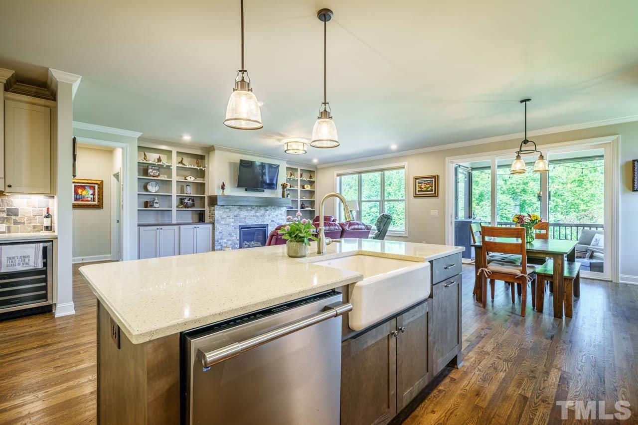 394 Cliffdale Road Chapel Hill, NC 27516 - Photo 17 of 66 a large kitchen with kitchen island a stove a sink a dining table and chairs