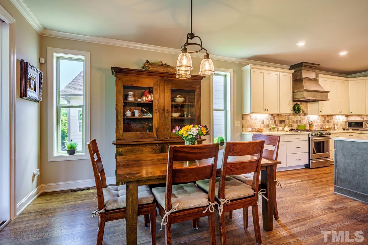 394 Cliffdale Road Chapel Hill, NC 27516 - Photo 20 of 66 a view of a dining room with furniture window and wooden floor