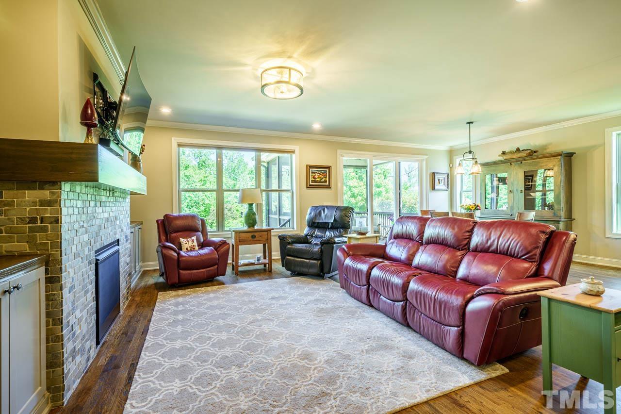 394 Cliffdale Road Chapel Hill, NC 27516 - Photo 24 of 66 a living room with furniture fireplace and a large window