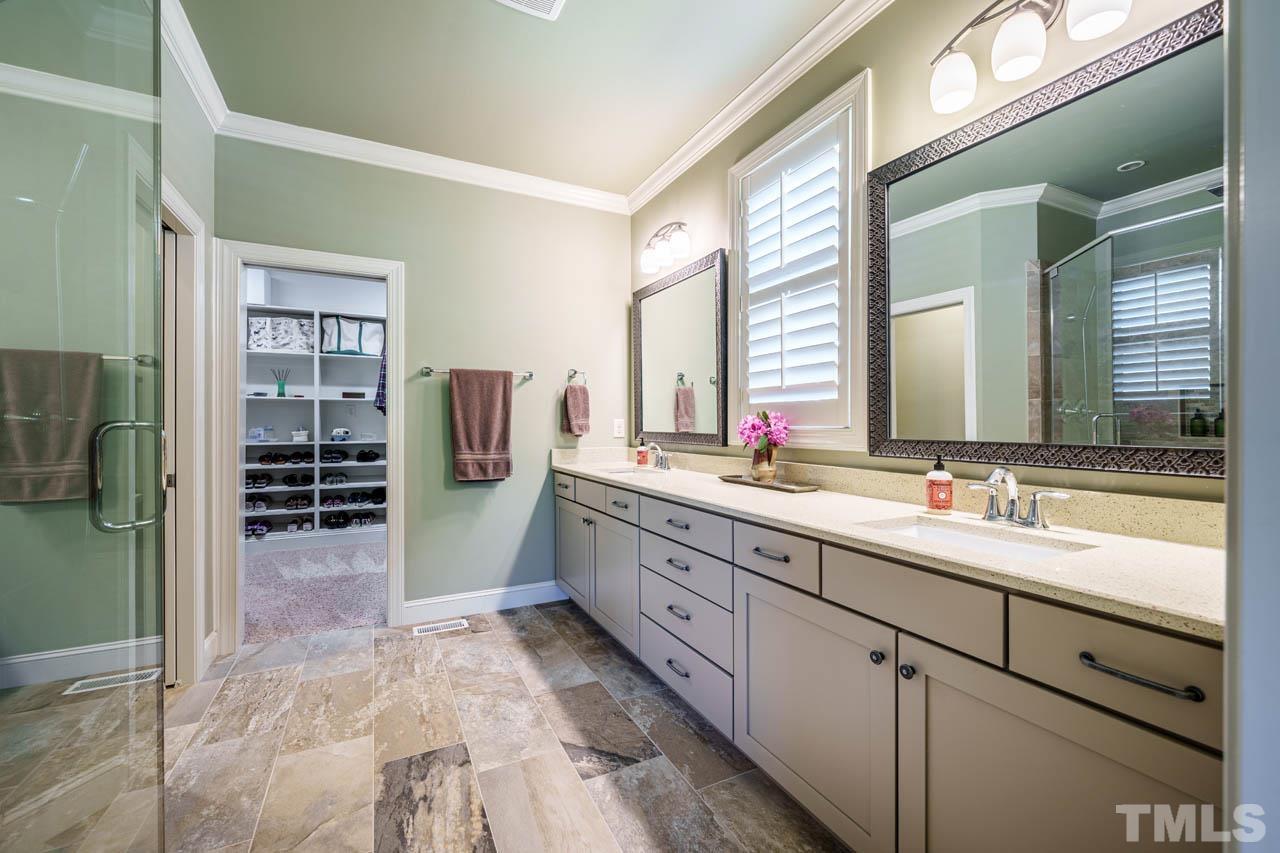 394 Cliffdale Road Chapel Hill, NC 27516 - Photo 29 of 66 a bathroom with a double vanity sink and mirror