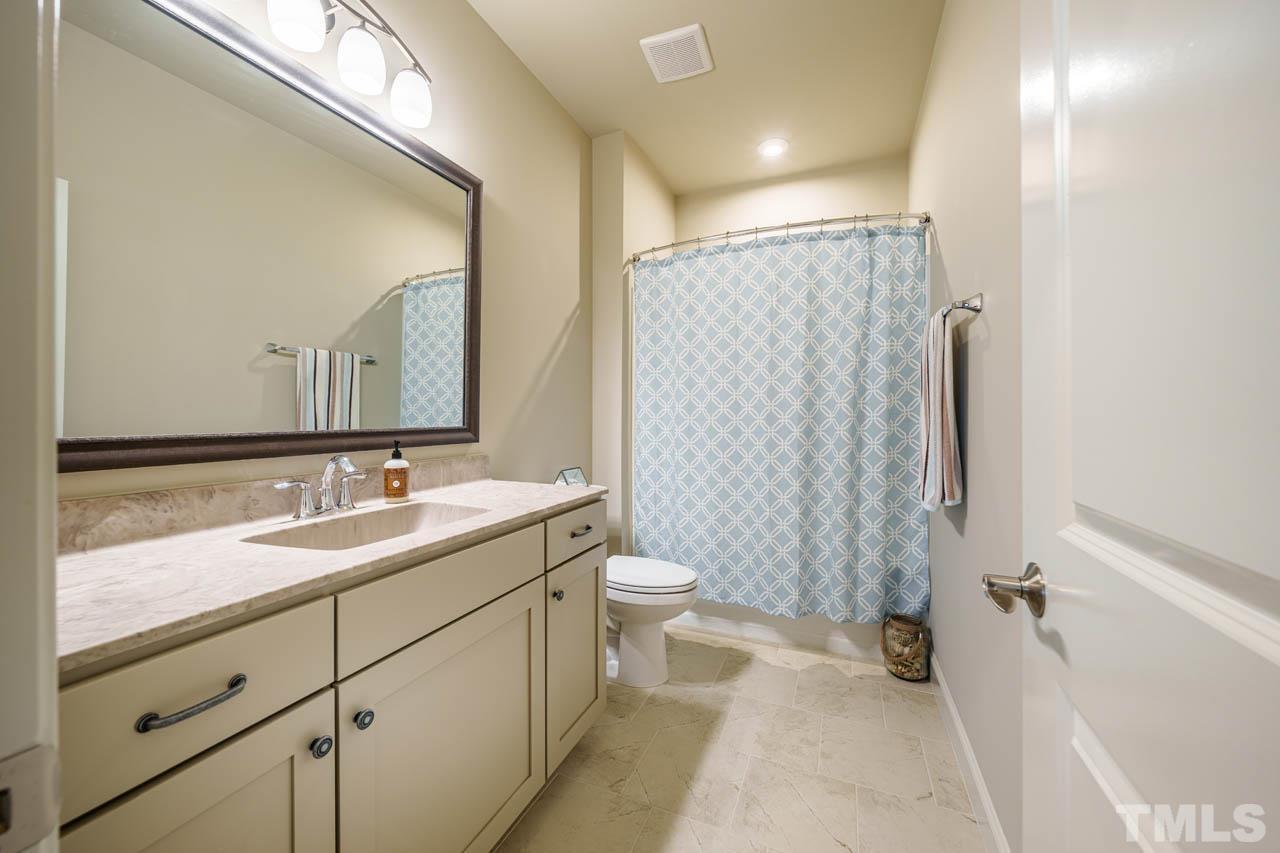 394 Cliffdale Road Chapel Hill, NC 27516 - Photo 42 of 66 a bathroom with a double vanity sink toilet and shower