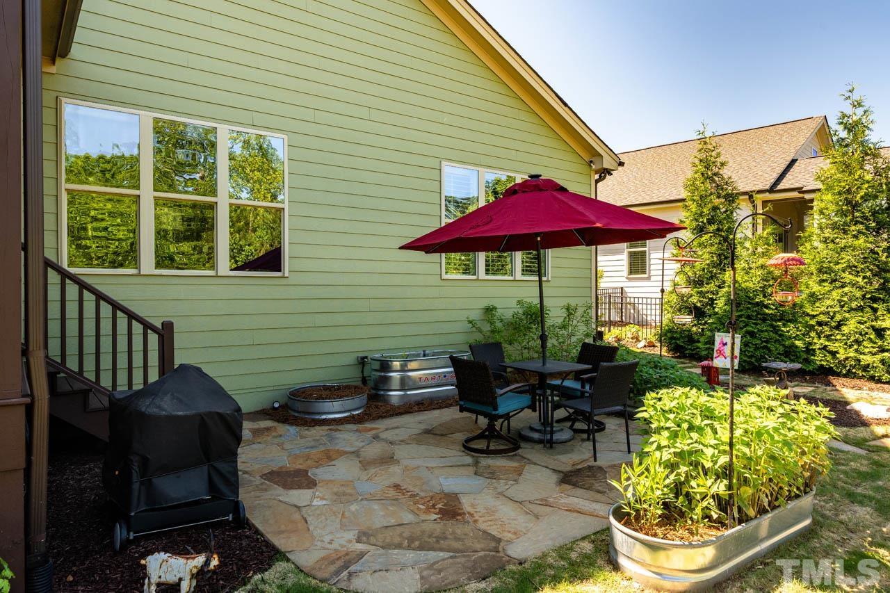 394 Cliffdale Road Chapel Hill, NC 27516 - Photo 48 of 66 a view of a patio with chairs and potted plants