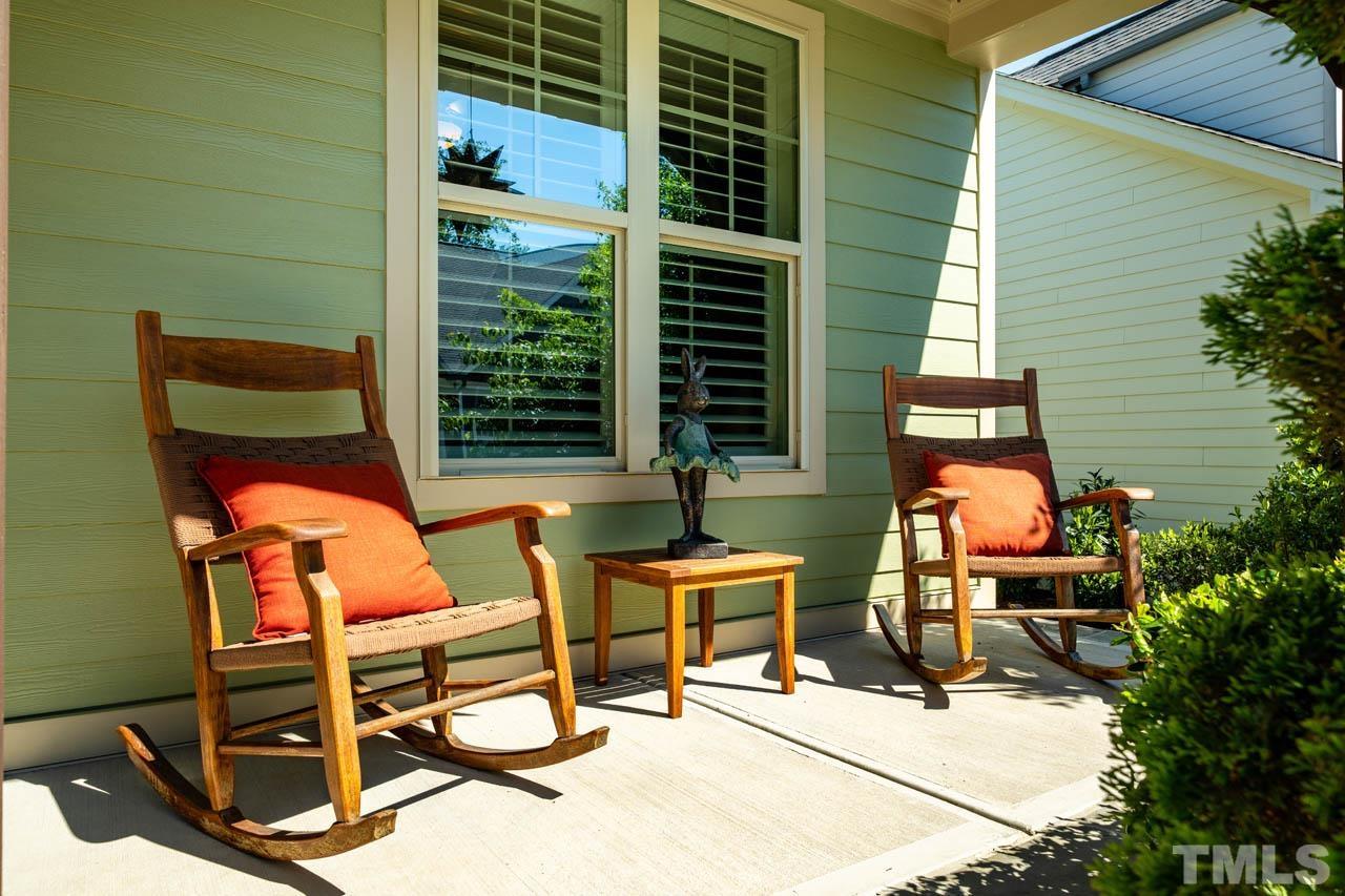 394 Cliffdale Road Chapel Hill, NC 27516 - Photo 6 of 66 a balcony with chairs and a potted plant