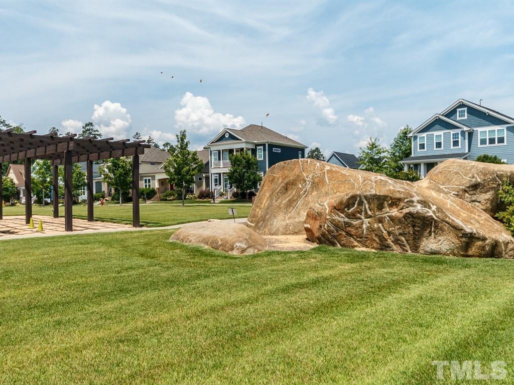 394 Cliffdale Road Chapel Hill, NC 27516 - Photo 62 of 66 a view of a park with multi story residential apartment building in the background