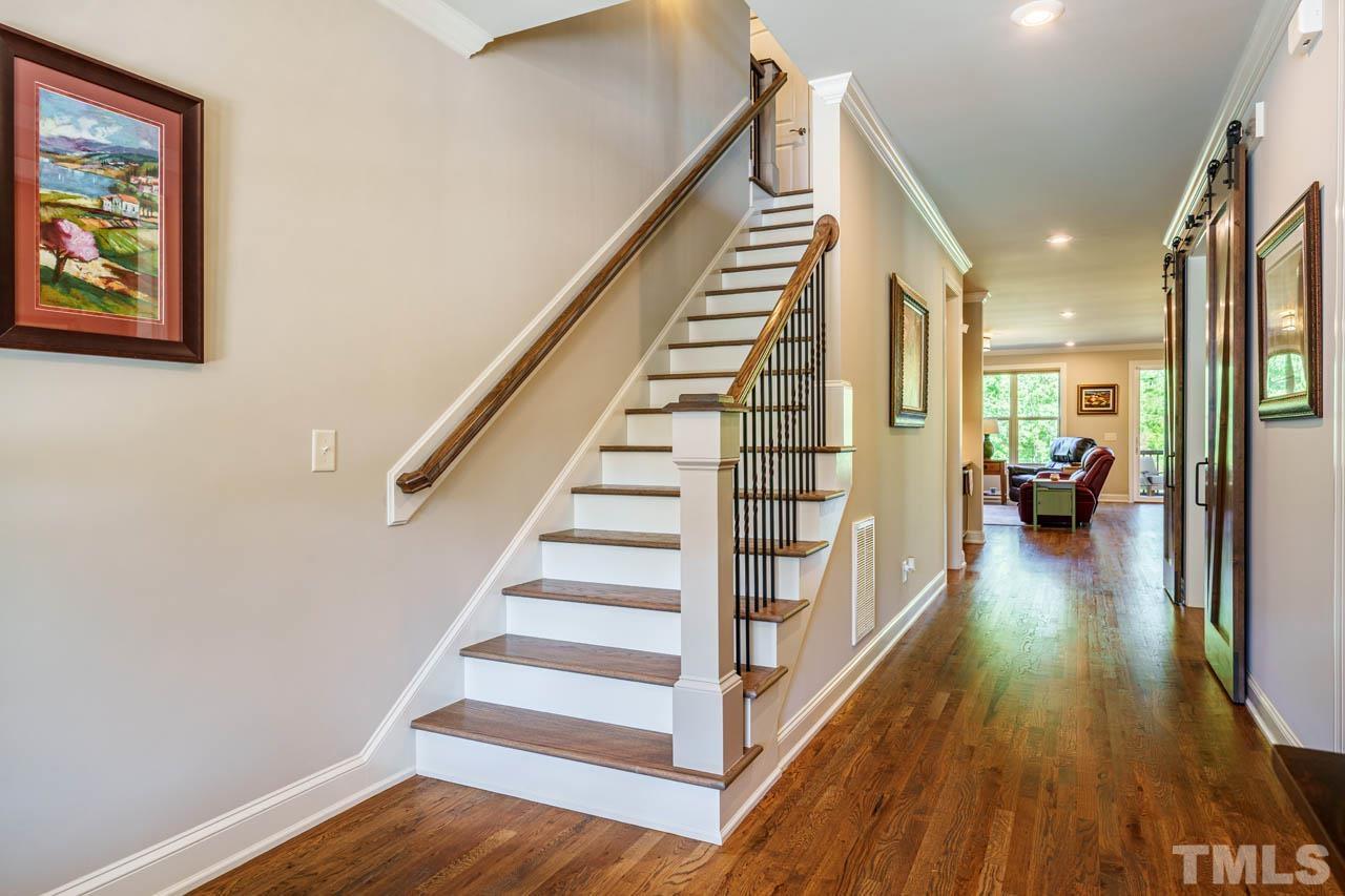 394 Cliffdale Road Chapel Hill, NC 27516 - Photo 9 of 66 a view of a hallway with wooden floor and staircase