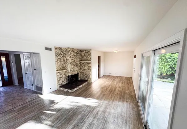 wooden floor in an empty room with a fireplace