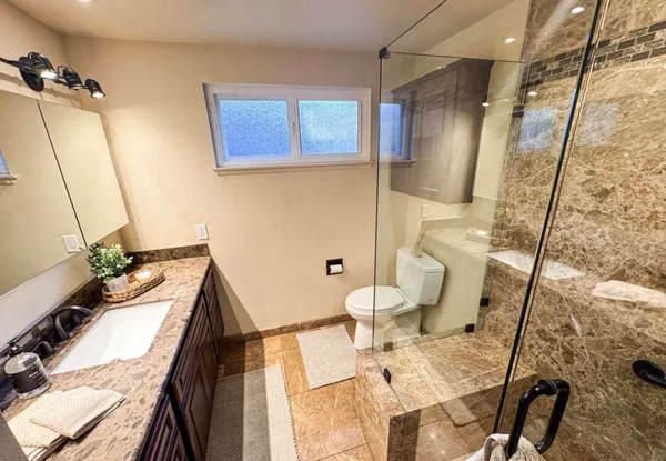 a bathroom with a sink mirror vanity and toilet