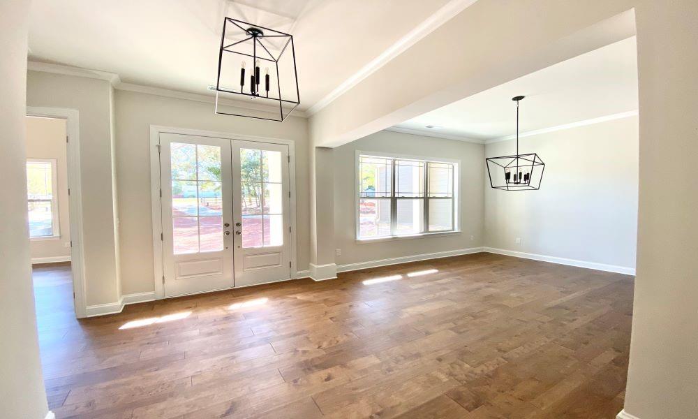 3848 Poplar Tent Road Concord, NC 28027 - Photo 7 of 12 an empty room with wooden floor and windows
