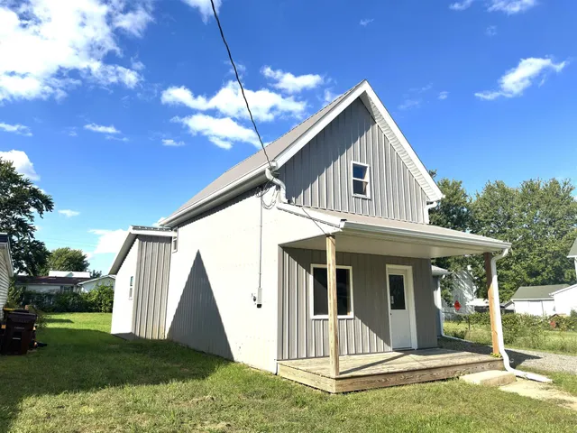 a front view of a house with a yard and porch