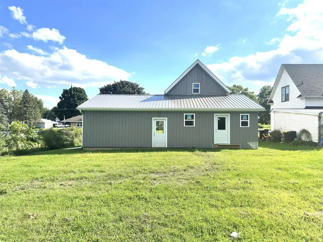 a house with huge green field in front of it