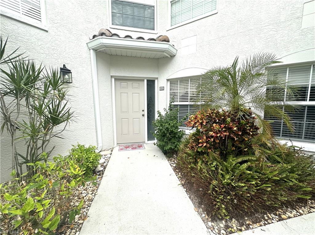 6816 Satinleaf Road South, Unit 102 Naples, FL 34109 - Photo 3 of 35 a view of a house with potted plants