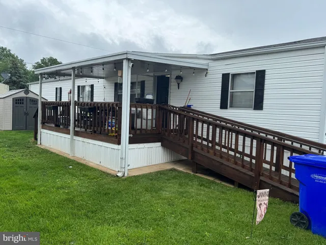 a view of a house with a yard and deck