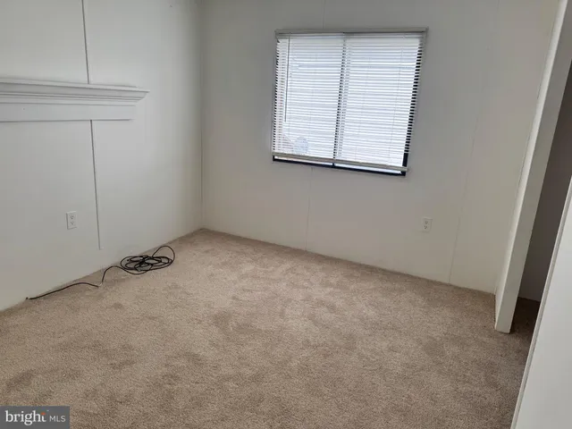a living room with blue walls and a large window