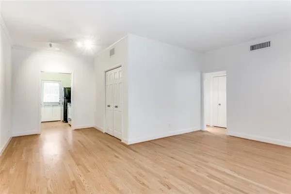 a view of an empty room and wooden floor