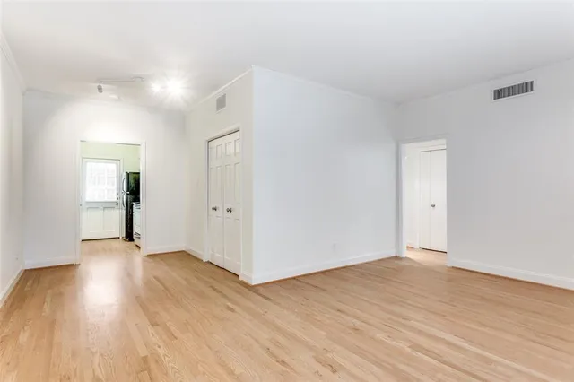 a view of an empty room and wooden floor