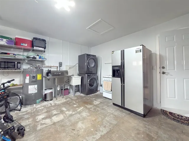 a view of a patio with a table and chairs under an umbrella