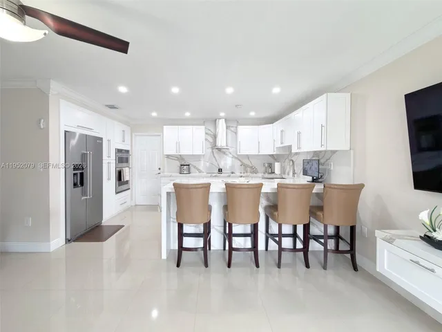a living room with furniture and kitchen view