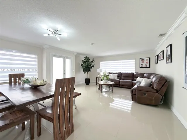 a view of a workspace with furniture and window