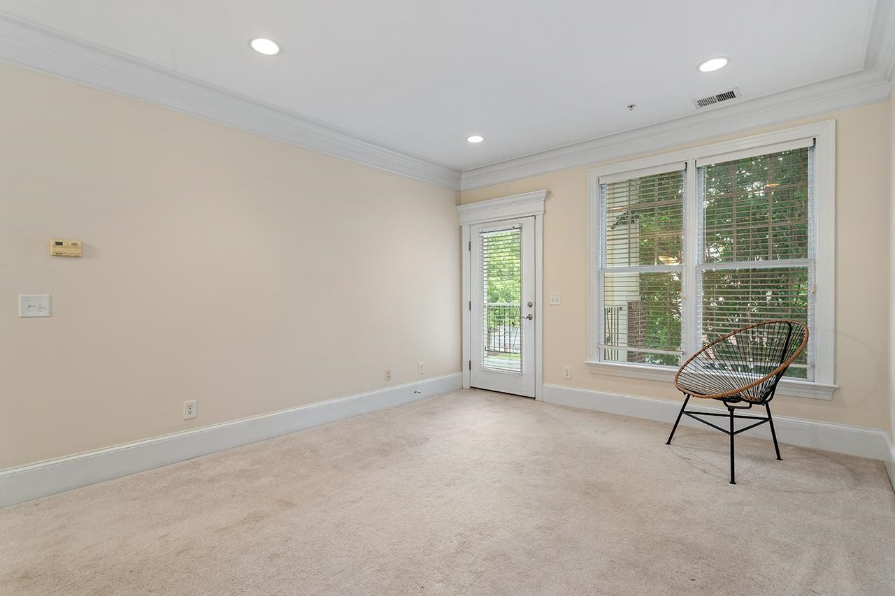 900 Canenaugh Drive, Unit 201 Raleigh, NC 27604 - Photo 20 of 28 a view of an empty room with wooden floor and a window