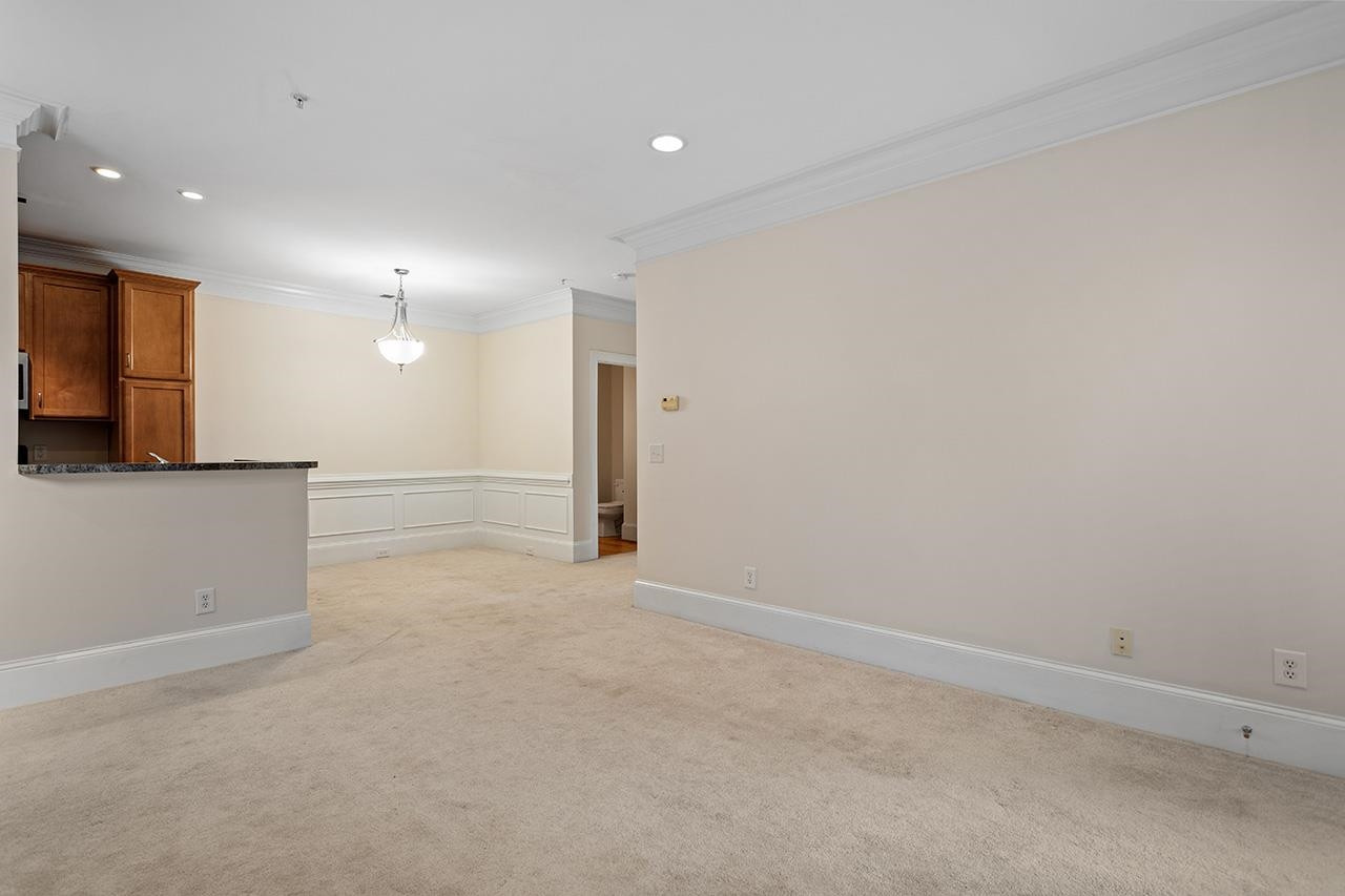 900 Canenaugh Drive, Unit 201 Raleigh, NC 27604 - Photo 21 of 28 an empty room with a cabinet and mirrors