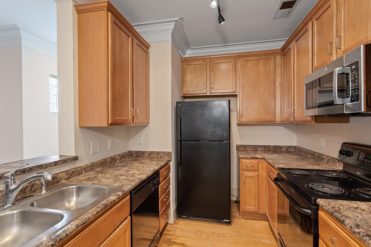 900 Canenaugh Drive, Unit 201 Raleigh, NC 27604 - Photo 4 of 28 a kitchen with a sink stove and refrigerator