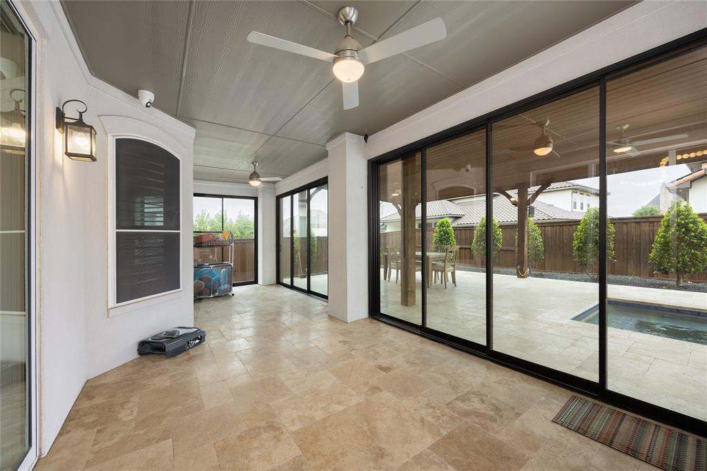918 Sydney Lane Allen, TX 75013 - Photo 30 of 40 The property features an expansive covered patio with ceiling fans and light-toned tile flooring