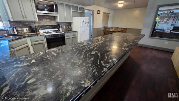 a kitchen with stainless steel appliances granite countertop a sink a stove and a wooden cabinets