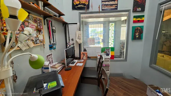 a living room with a bed furniture and a flat screen tv