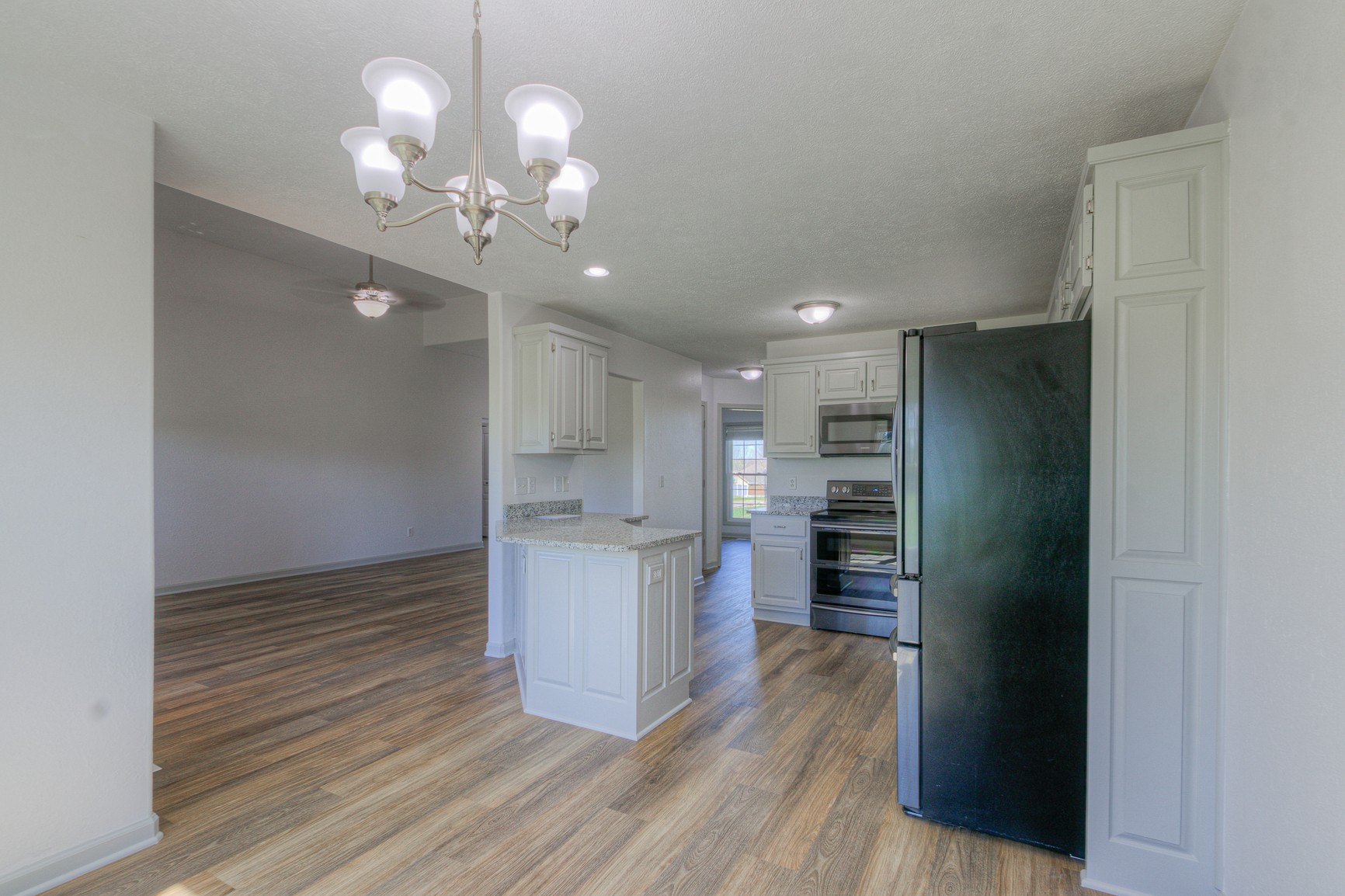 1208 Hunters Point Lane Spring Hill, TN 37174 - Photo 11 of 31 a kitchen with stainless steel appliances granite countertop a refrigerator and a stove top oven