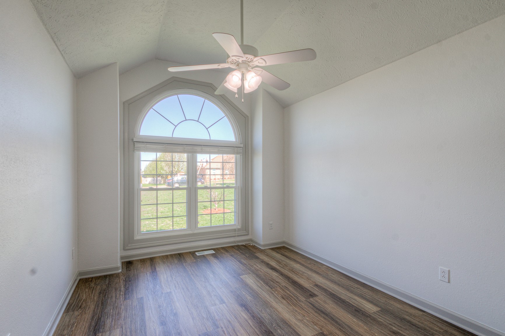1208 Hunters Point Lane Spring Hill, TN 37174 - Photo 25 of 31 an empty room with wooden floor chandelier fan and windows