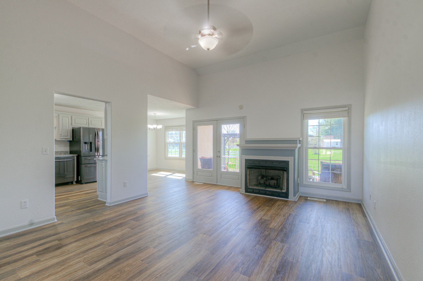 1208 Hunters Point Lane Spring Hill, TN 37174 - Photo 8 of 31 an empty room with wooden floor fireplace and windows