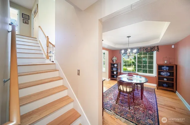 a view of a hallway with furniture and wooden floor