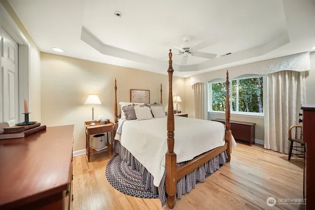 a spacious bathroom with a tub sink and mirror