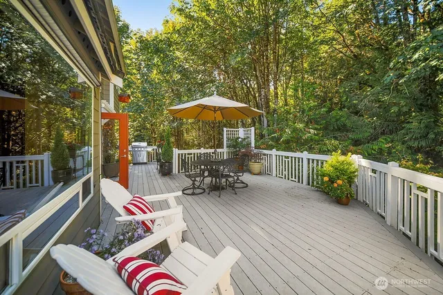 a view of patio with table and chairs under an umbrella