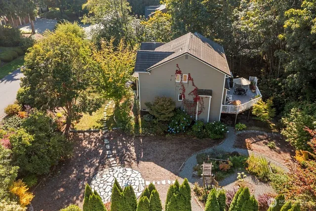 an aerial view of a house with a yard