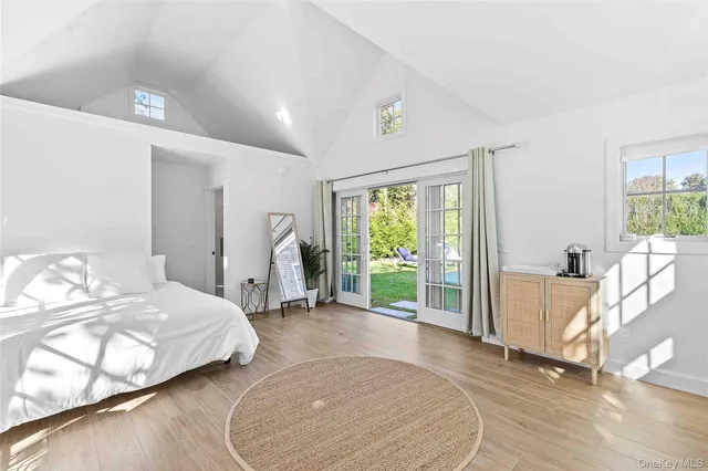 a spacious bedroom with a bed and a large window