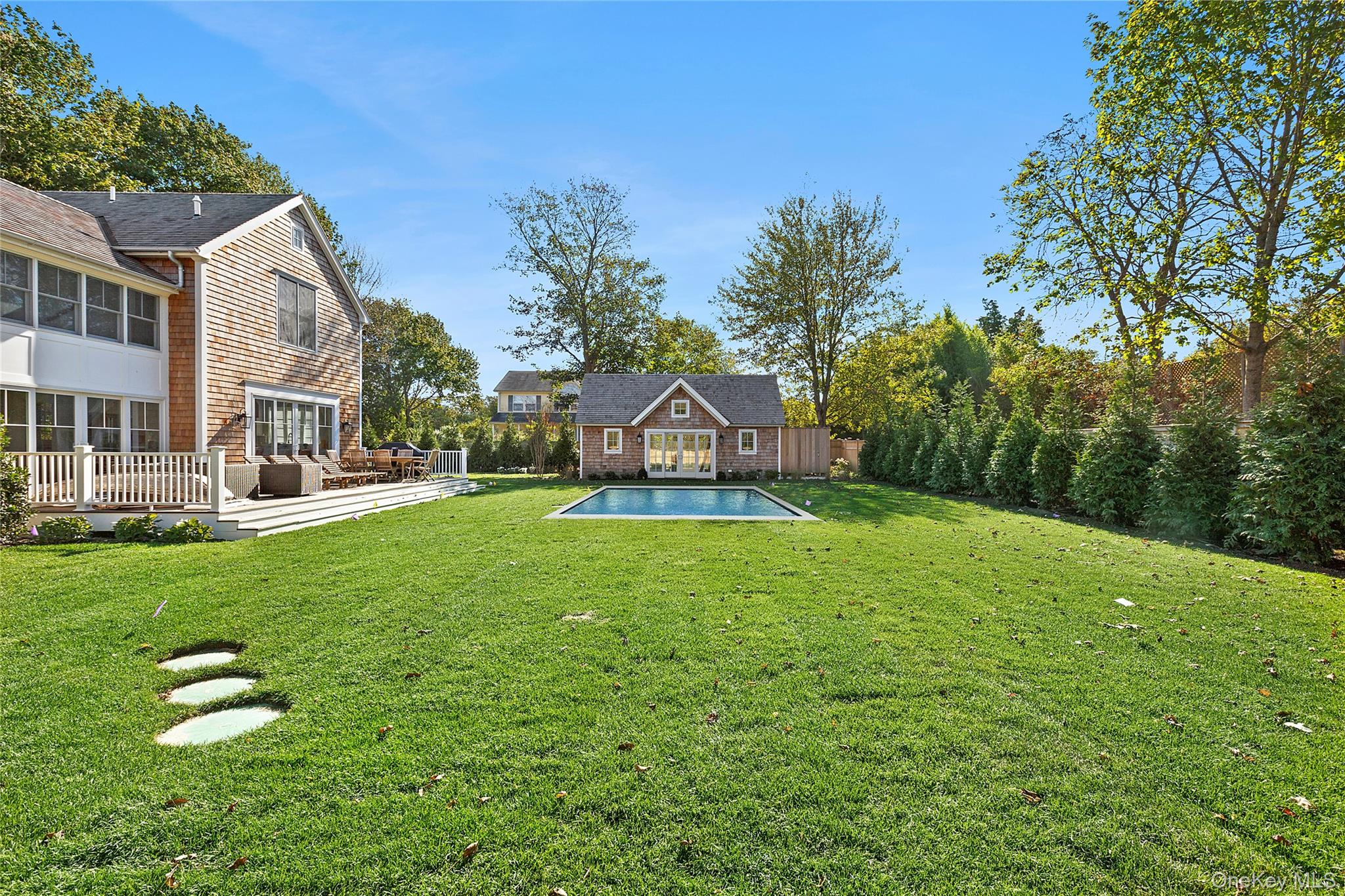 96 Miller Road Southampton, NY 11968 - Photo 3 of 15 a view of a house with a big yard and large trees
