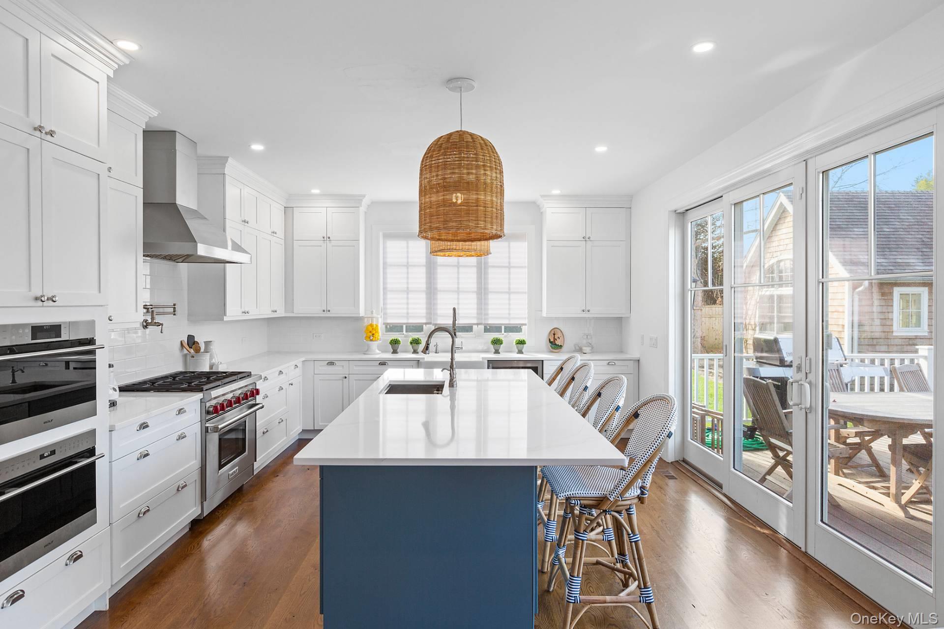 96 Miller Road Southampton, NY 11968 - Photo 4 of 15 a kitchen with stainless steel appliances granite countertop a stove a sink dishwasher a microwave oven and a dining table with wooden floor