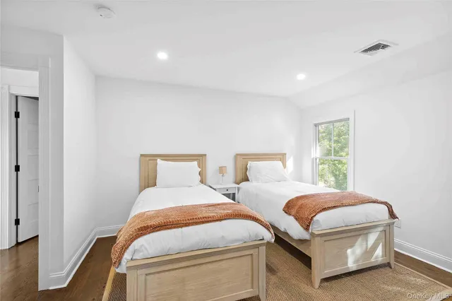 a bedroom with two beds and a window