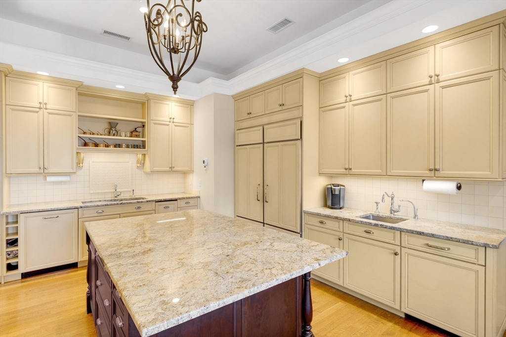 26 Winter Street Salem, MA 01970 - Photo 12 of 42 a kitchen with stainless steel appliances granite countertop a sink and cabinets