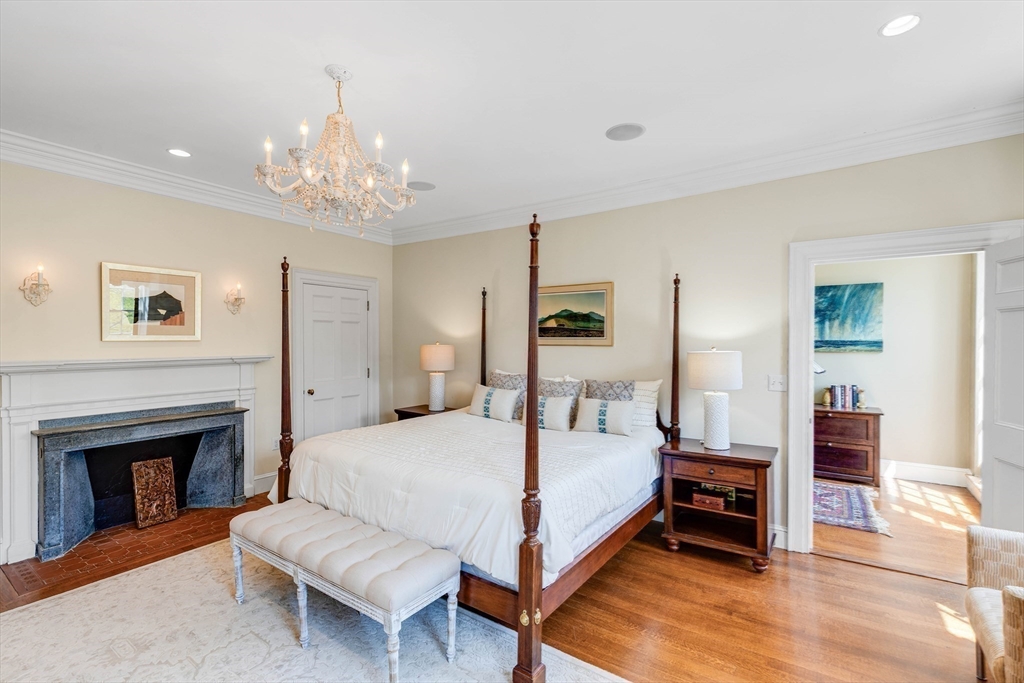 26 Winter Street Salem, MA 01970 - Photo 21 of 42 a spacious bedroom with a bed and a chandelier