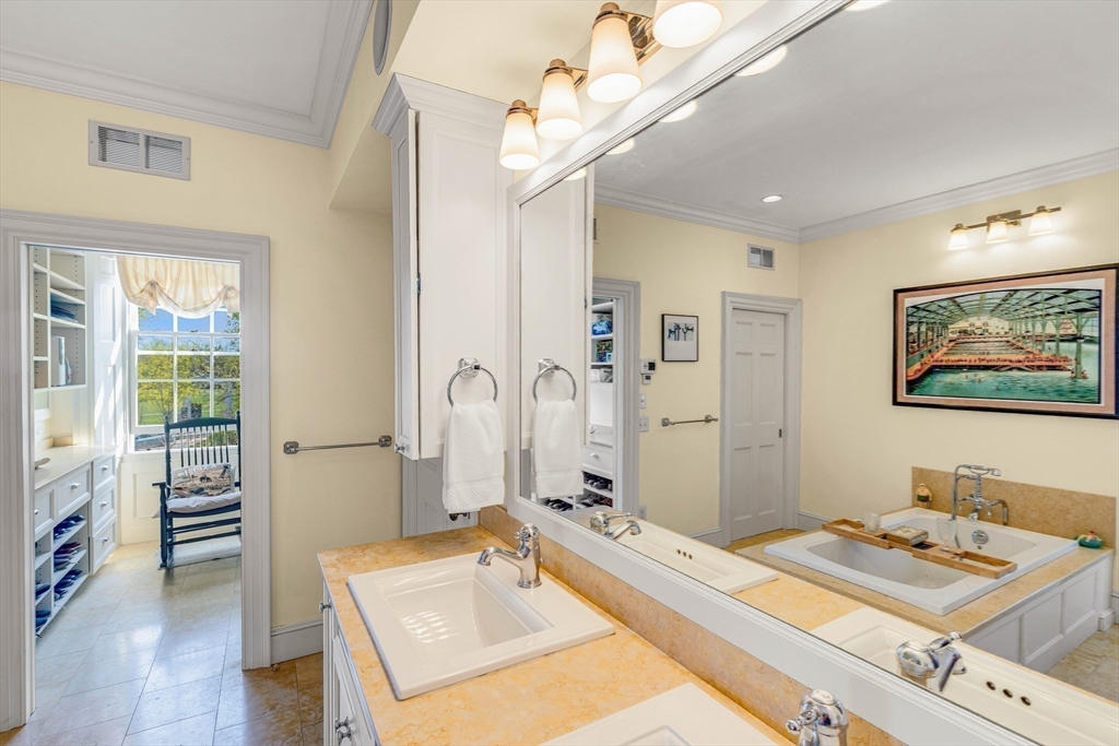 26 Winter Street Salem, MA 01970 - Photo 25 of 42 a spacious bedroom with a bed and a chandelier