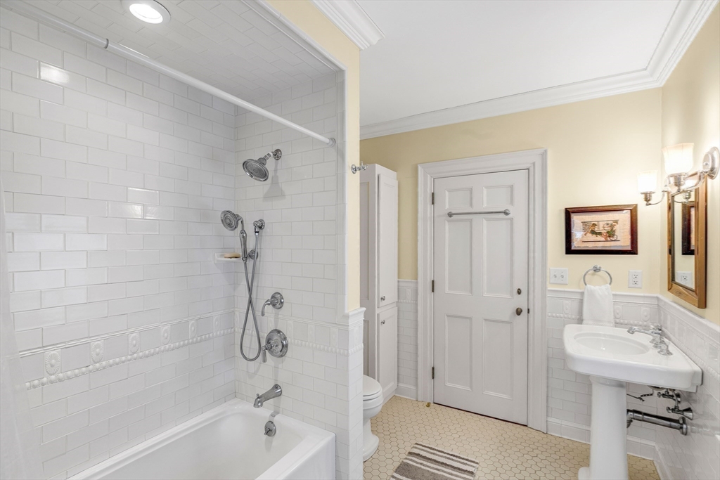 26 Winter Street Salem, MA 01970 - Photo 28 of 42 a bathroom with a bathtub shower sink mirror and toilet