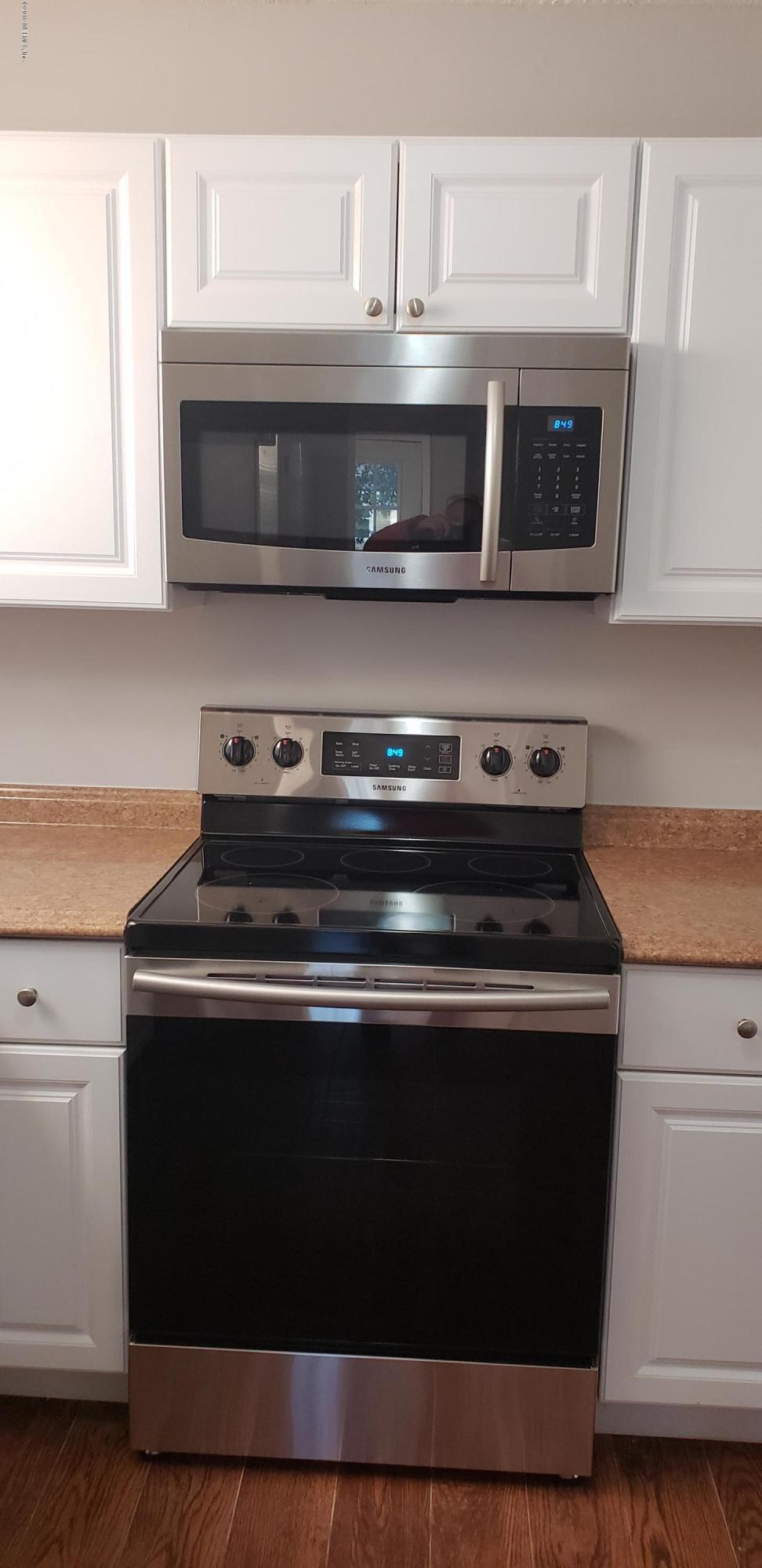 4633 Manchester Road Jacksonville, FL 32210 - Photo 11 of 26 a stove top oven sitting inside of a kitchen