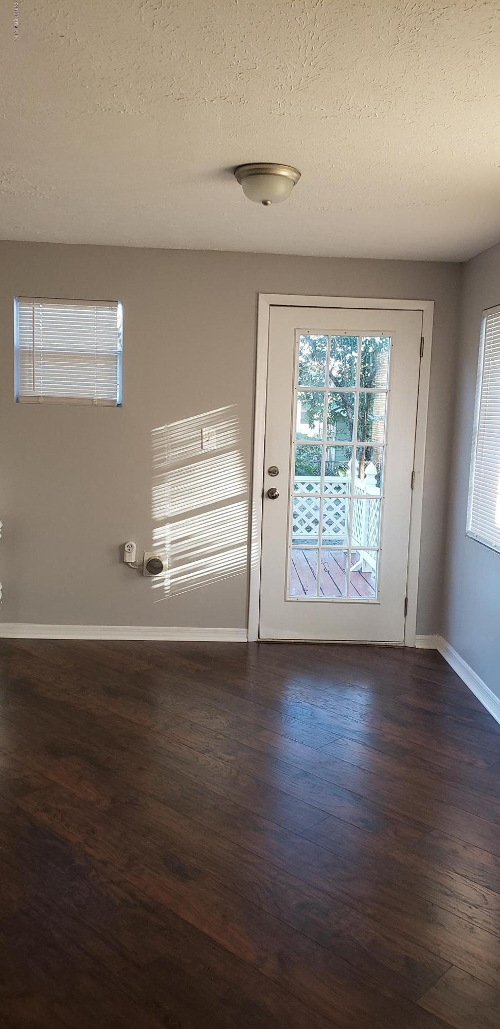 4633 Manchester Road Jacksonville, FL 32210 - Photo 15 of 26 wooden floor in an empty room with a window