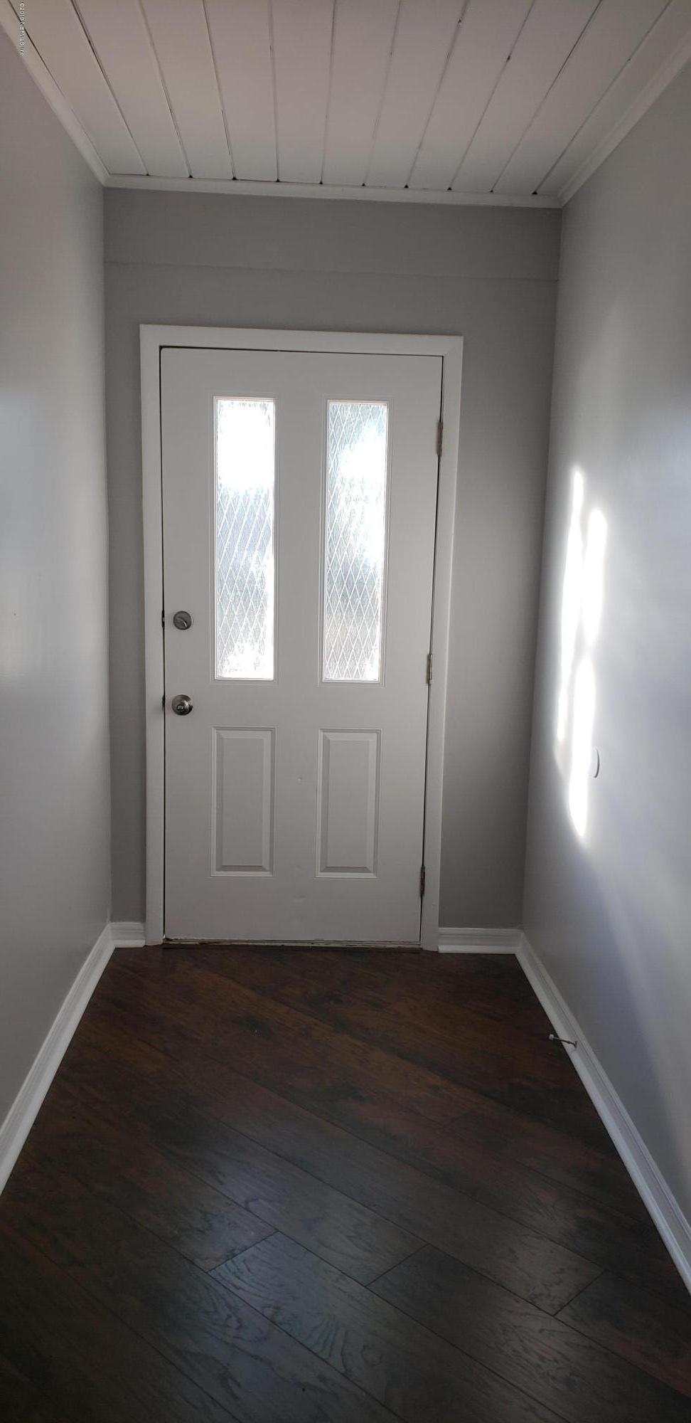4633 Manchester Road Jacksonville, FL 32210 - Photo 20 of 26 an empty room with wooden floor and windows