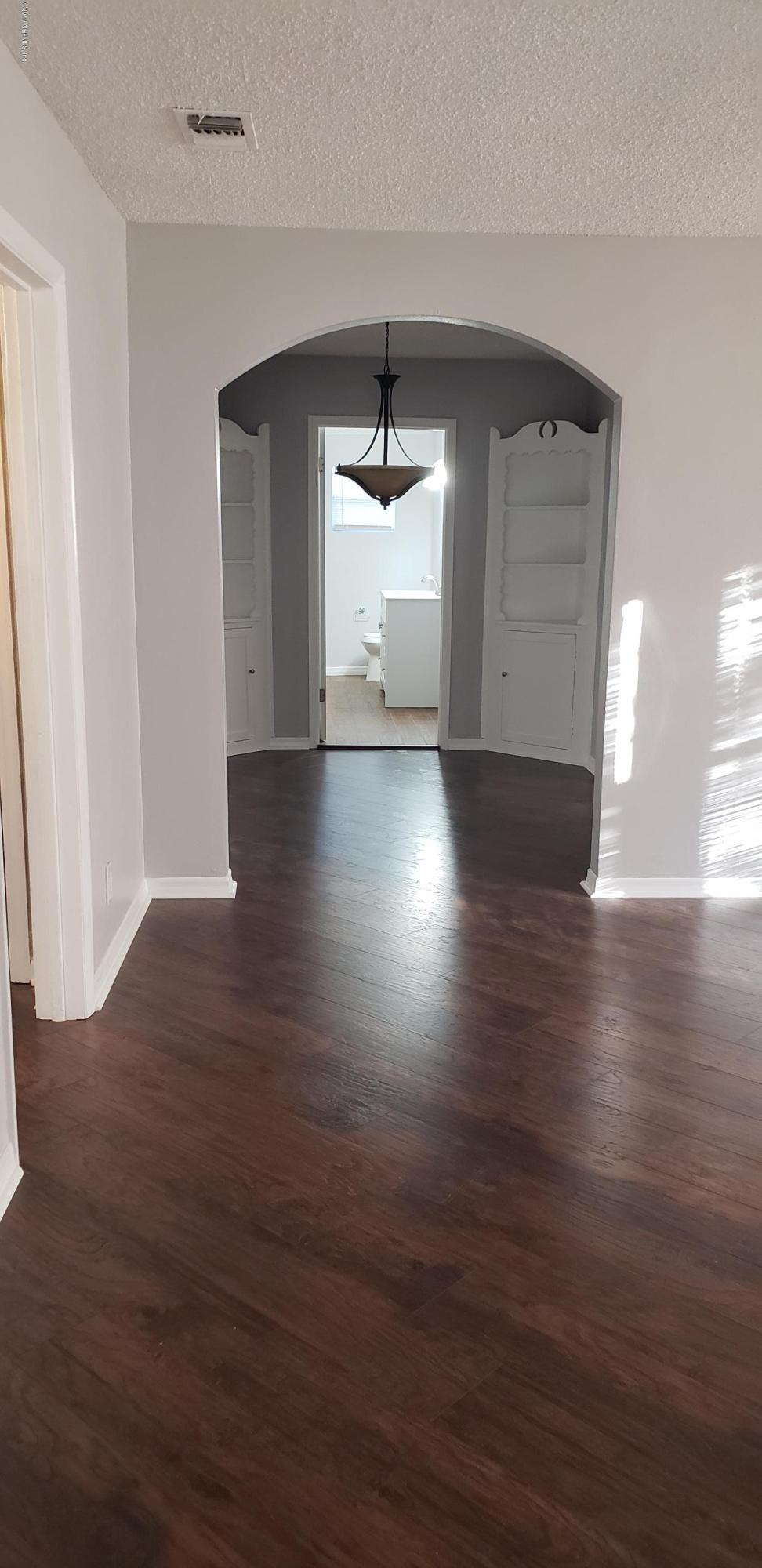 4633 Manchester Road Jacksonville, FL 32210 - Photo 22 of 26 a view of a livingroom with wooden floor and a window
