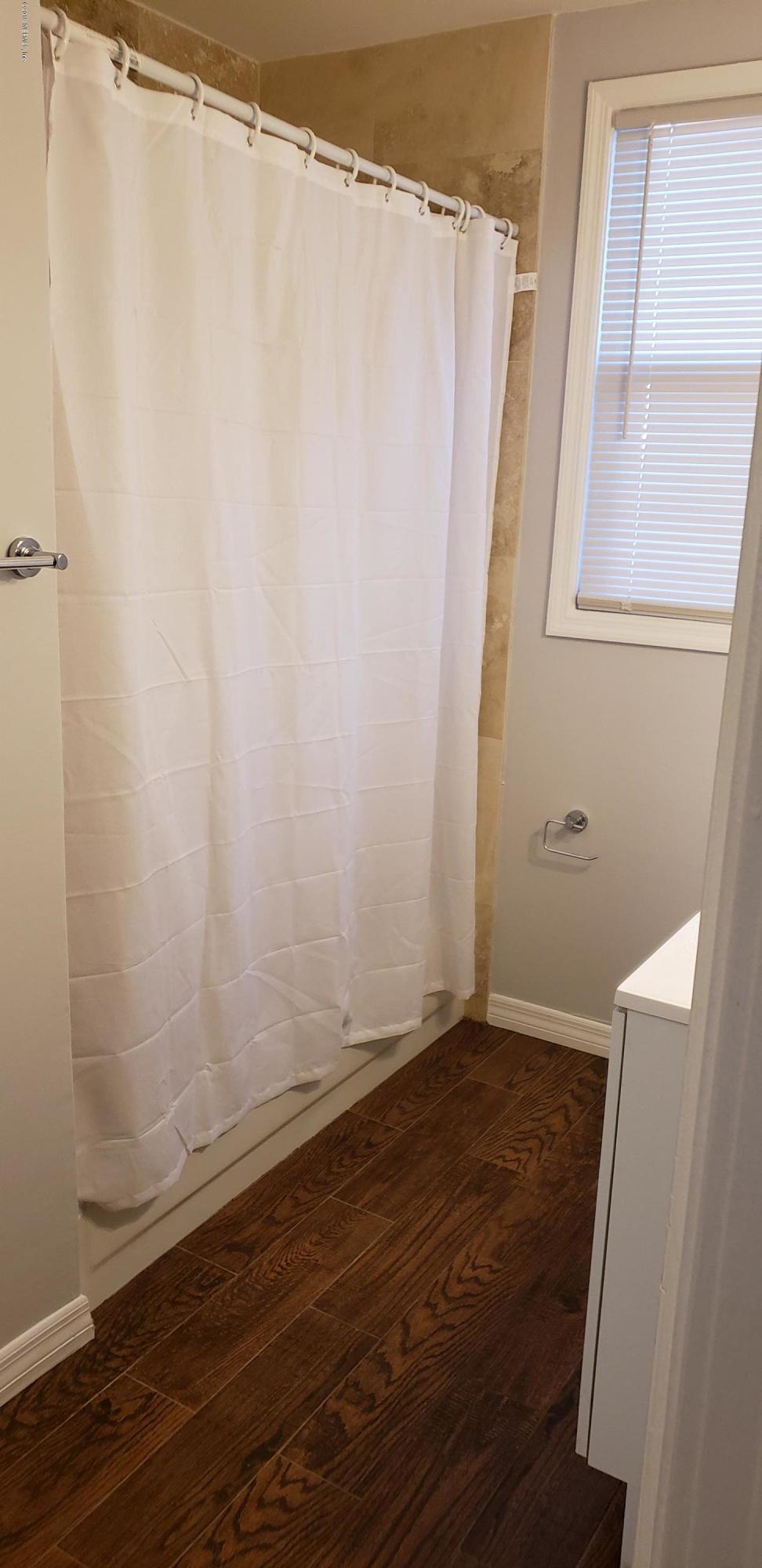 4633 Manchester Road Jacksonville, FL 32210 - Photo 26 of 26 a view of a room with wooden floor and fan